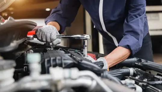 picture of a mechanic servicing a car