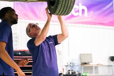 Mechanics checking tyre at cinch service centre