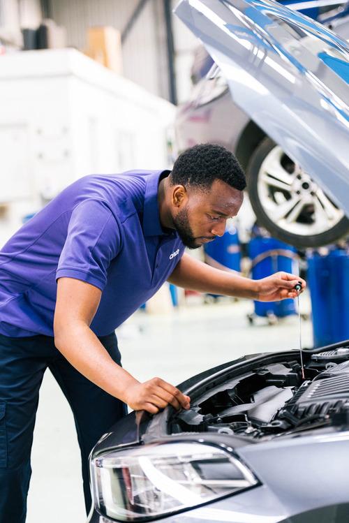 Mechanic checking oil filter at cinch service centre